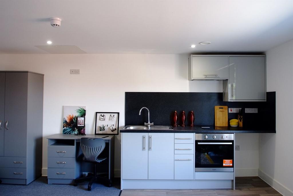This modern kitchen features sleek cabinetry an...
