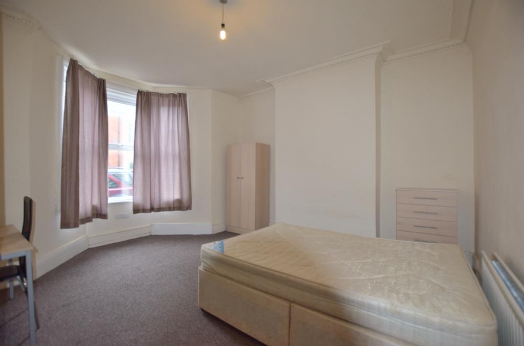 A spacious and bright double bedroom with large...