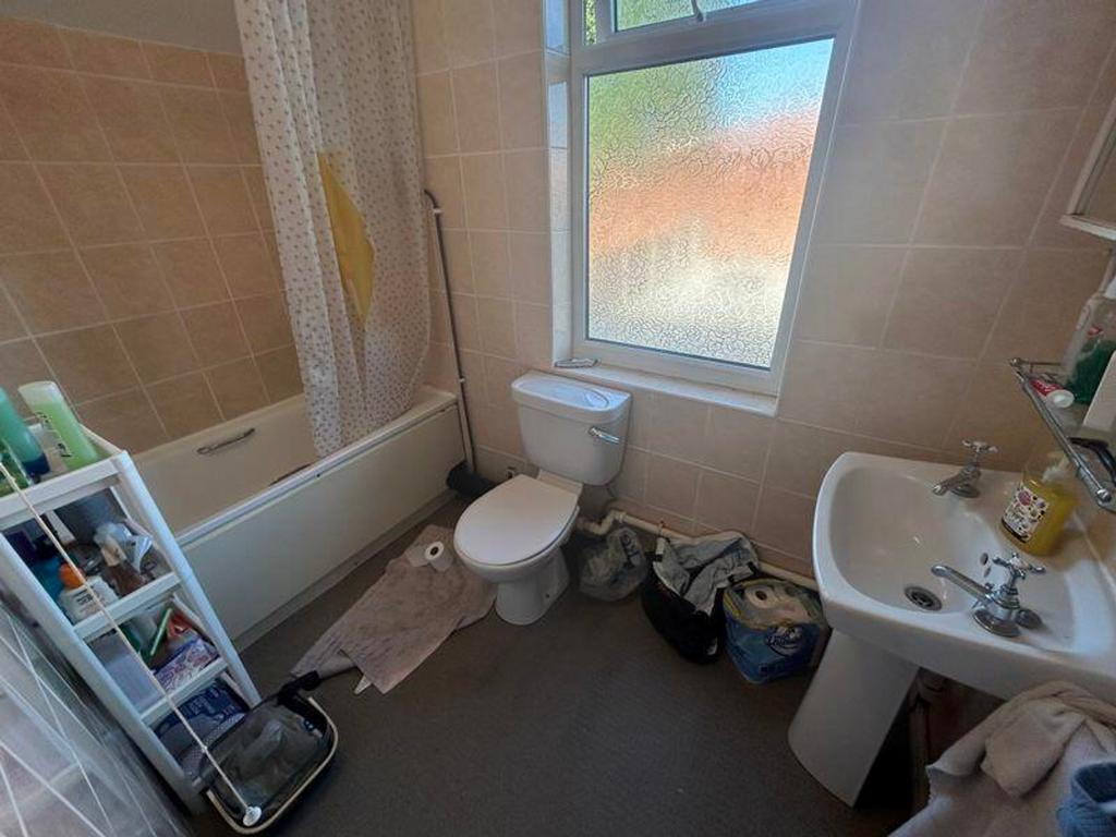 A bright and functional bathroom featuring a ba...
