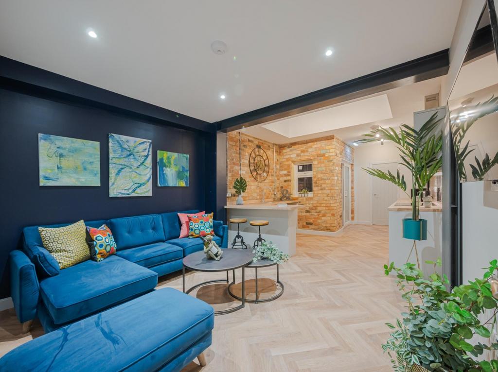 This stylish living room features a cozy seatin...