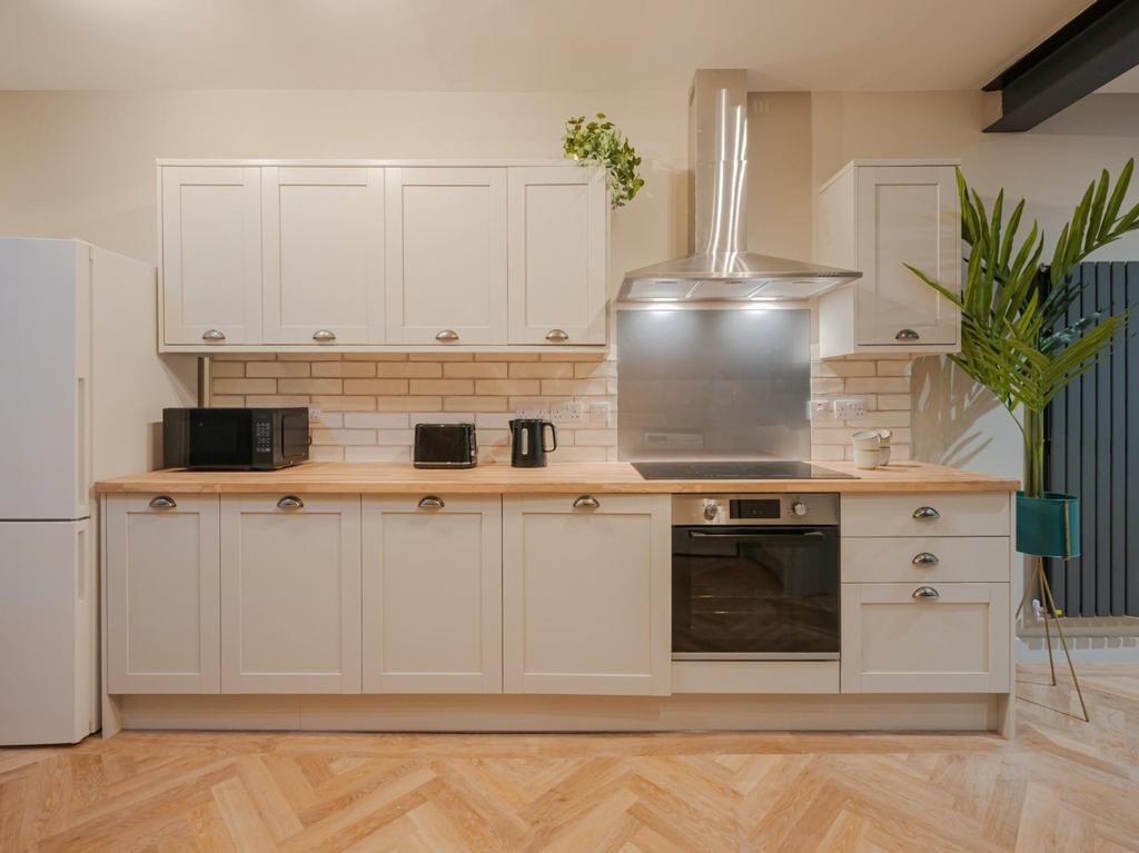 Modern kitchen featuring sleek cabinetry, ample...