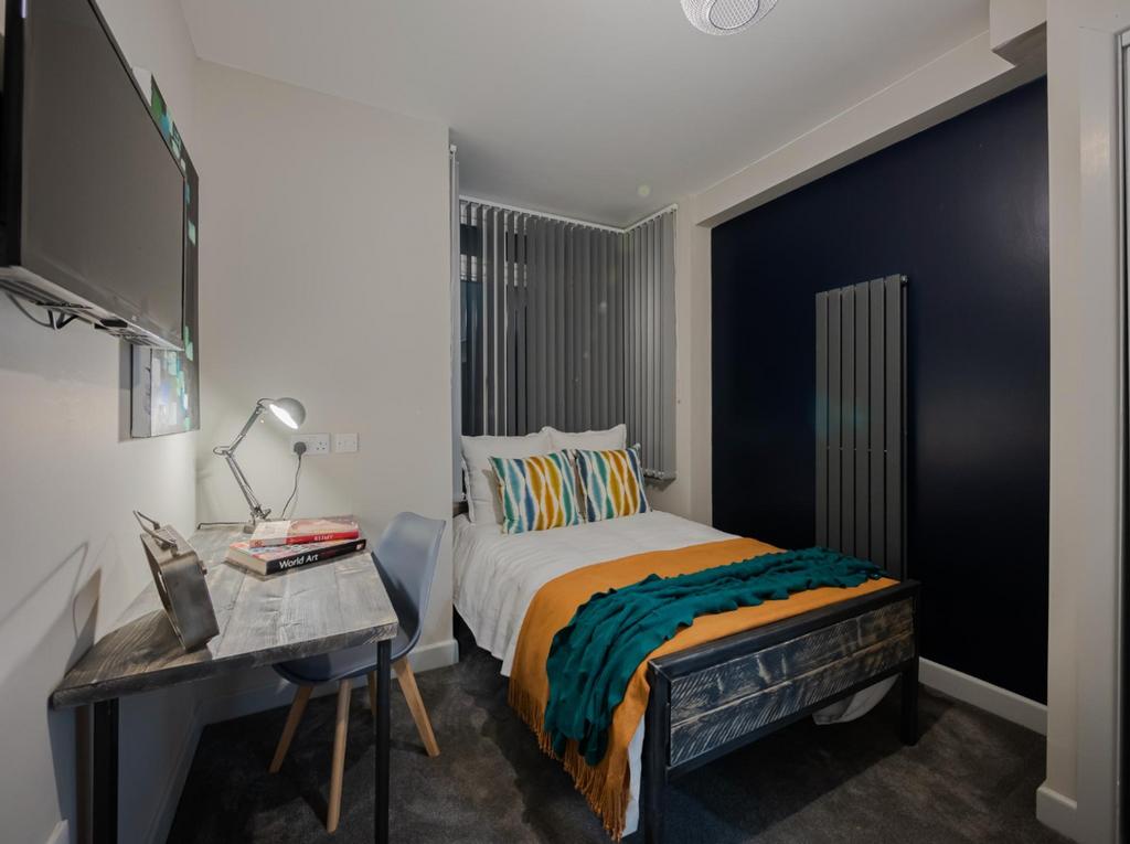 This stylish double bedroom features a cozy bed...