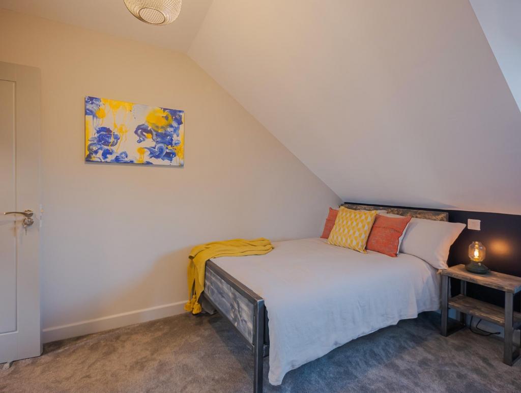 This cozy double bedroom features a comfortable...