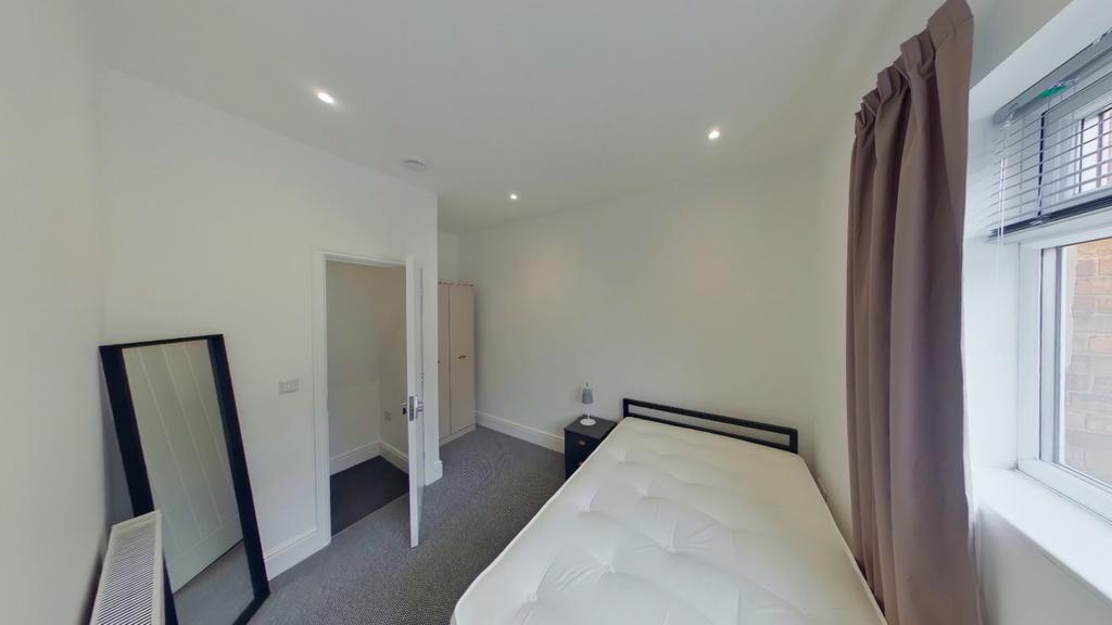 A bright and inviting double bedroom with moder...