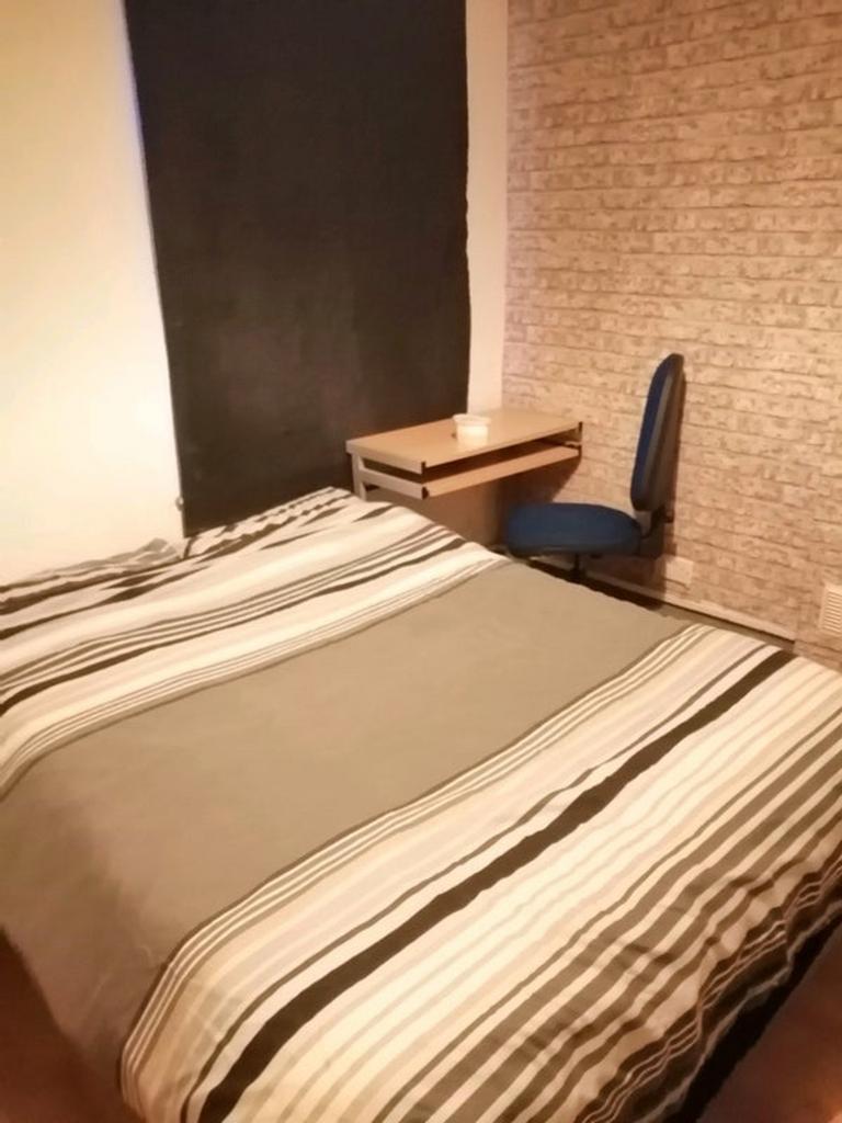 A cozy double bedroom featuring a comfortable b...