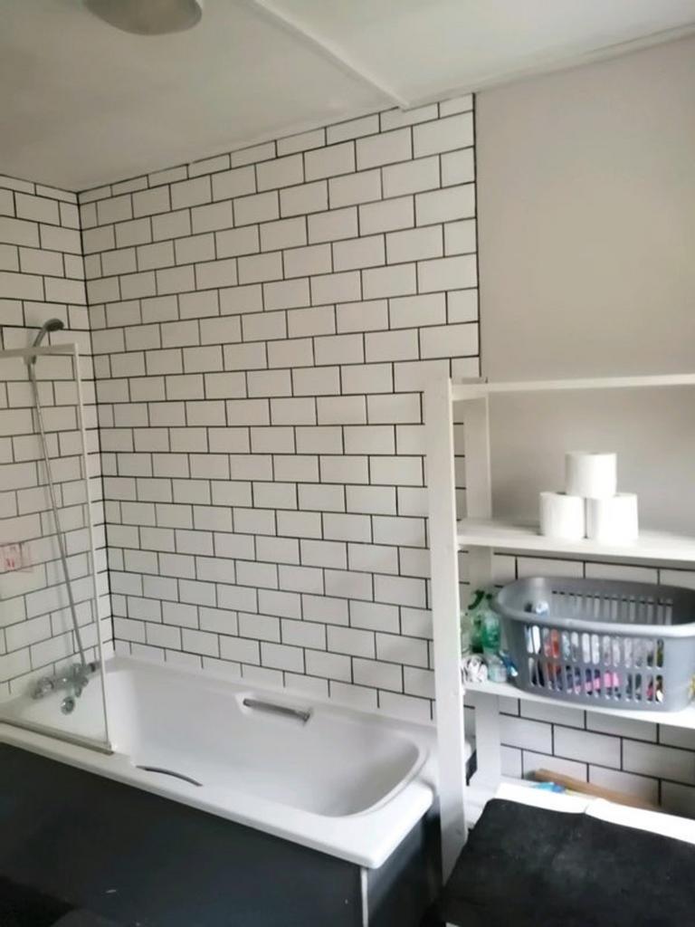 A modern bathroom featuring a clean white batht...