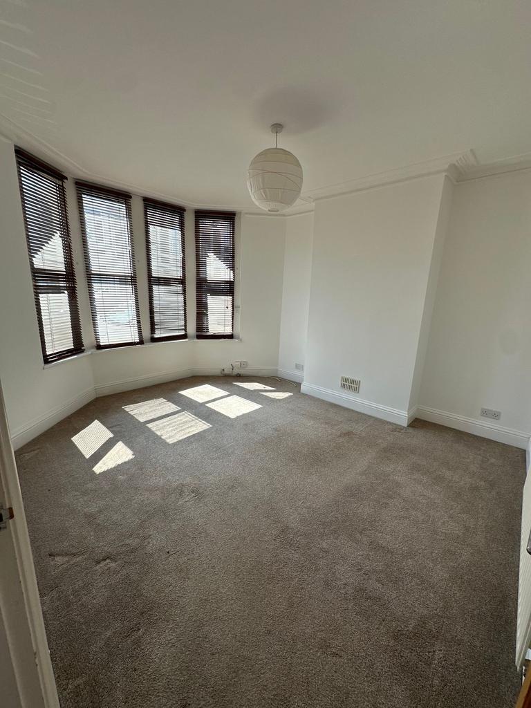 A bright and spacious living room featuring lar...