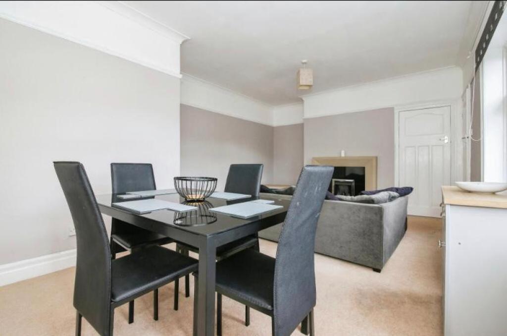 Spacious living room featuring a modern dining ...