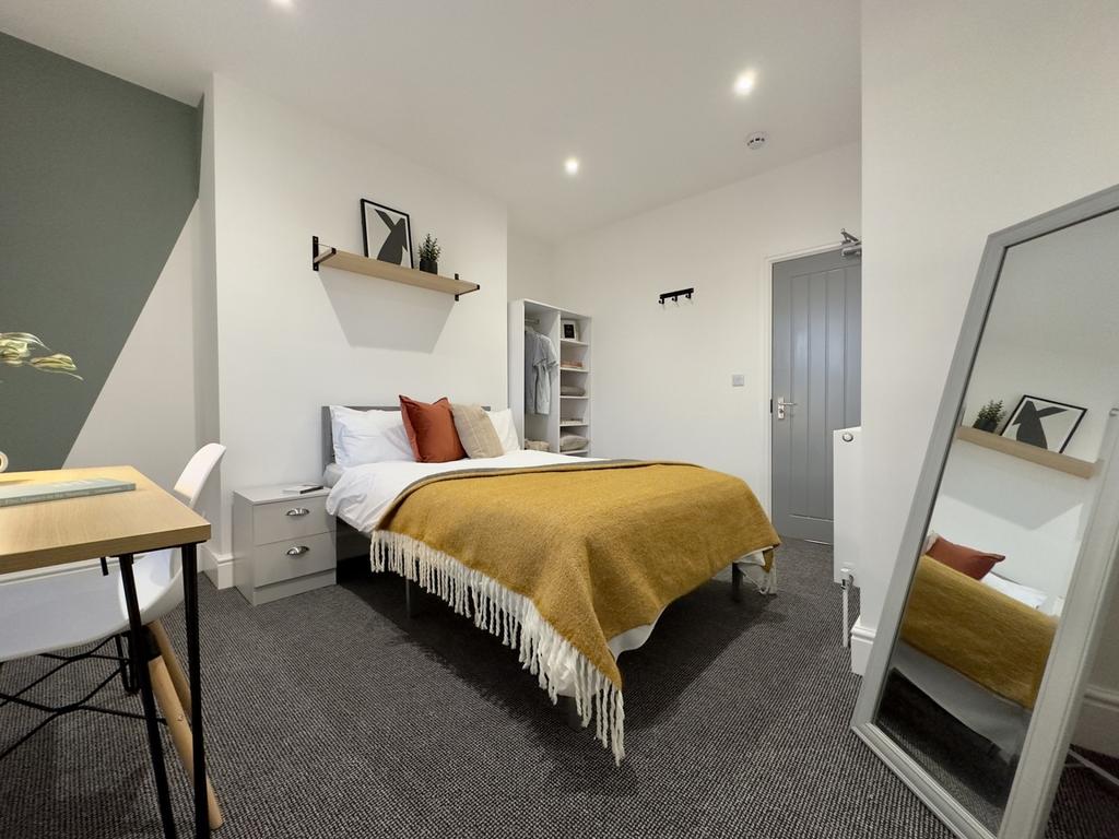A stylish and spacious double bedroom featuring...