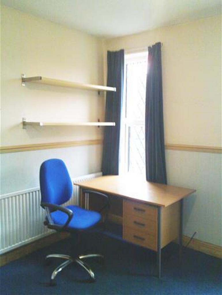 Bright and inviting communal workspace featurin...