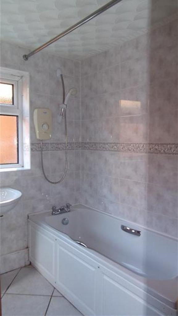 A well-maintained bathroom featuring a spacious...