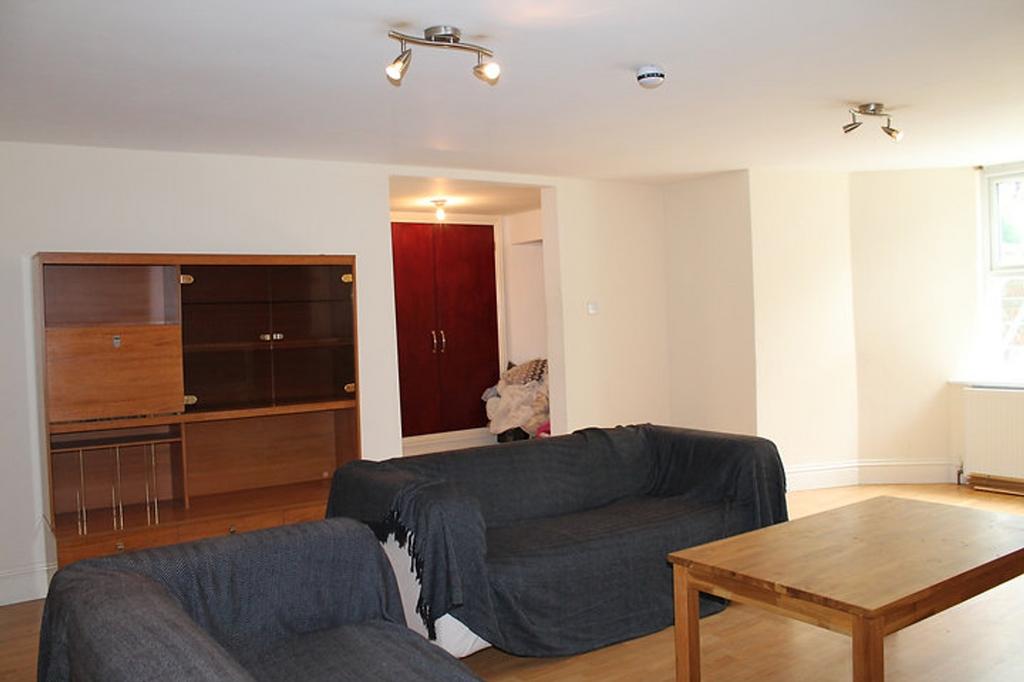 Spacious and inviting living room featuring coz...