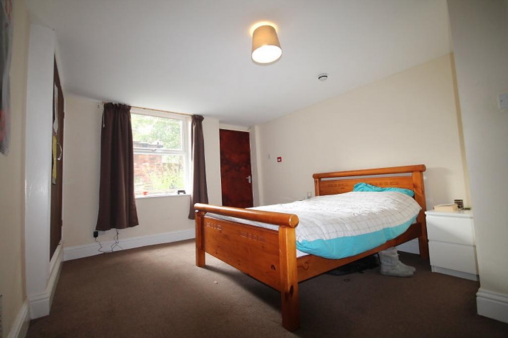 This inviting double bedroom features a warm wo...