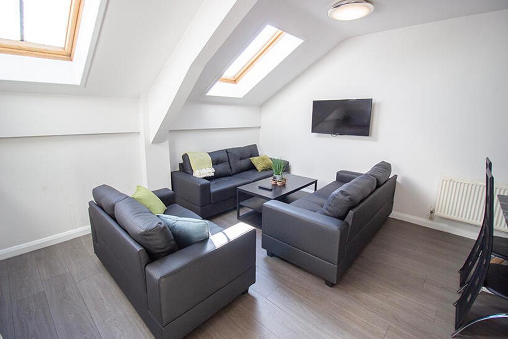 A bright and spacious living room featuring con...
