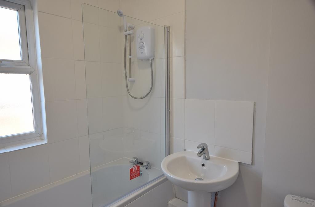 A well-maintained bathroom featuring a shower a...