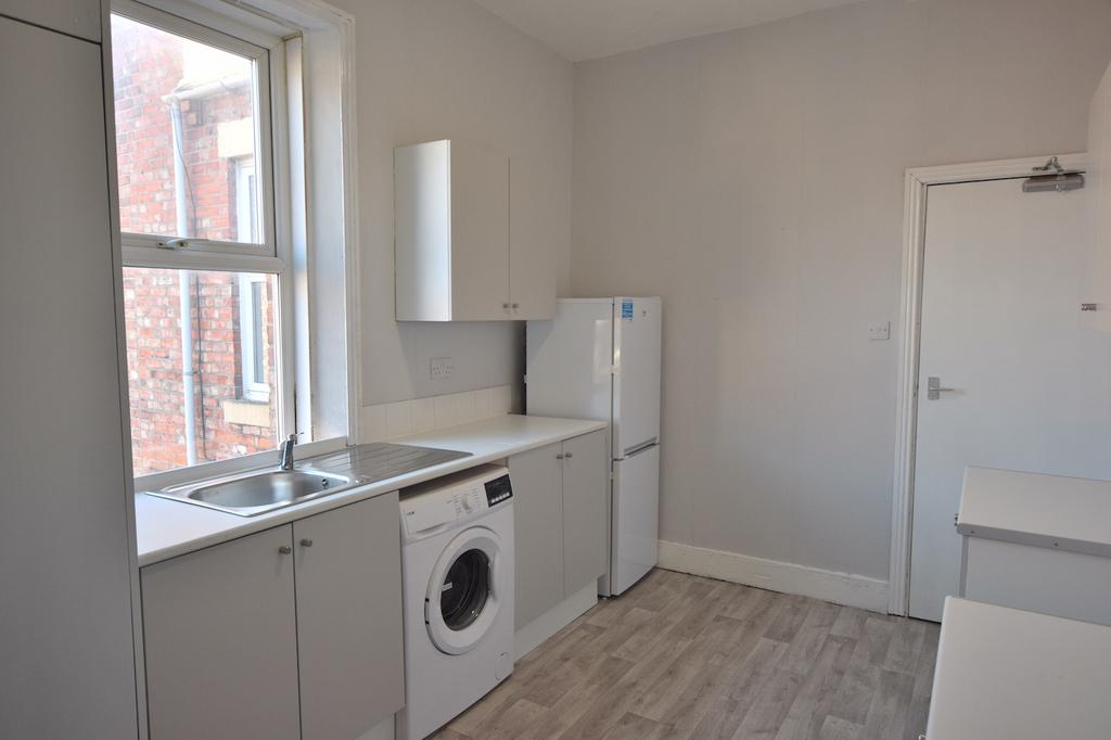 Bright and modern kitchen featuring ample stora...