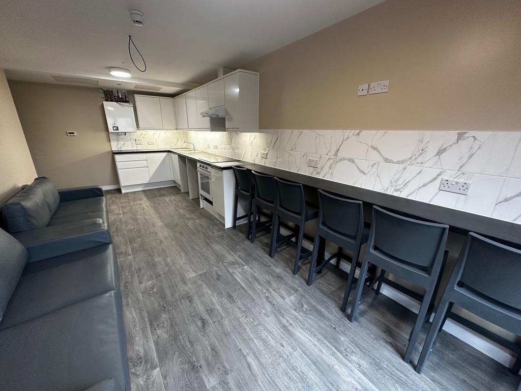 Spacious and modern kitchen area featuring slee...