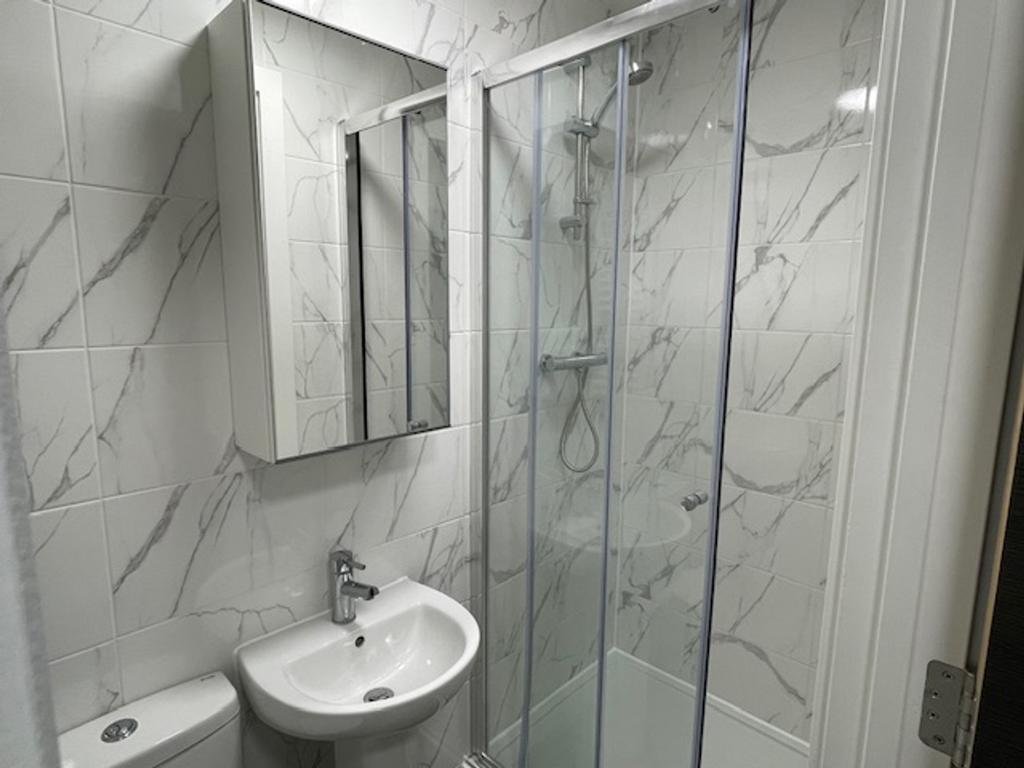 Modern bathroom featuring elegant marble tiles,...