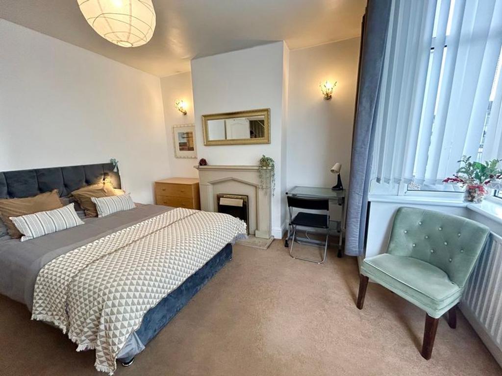 A spacious and inviting double bedroom featurin...