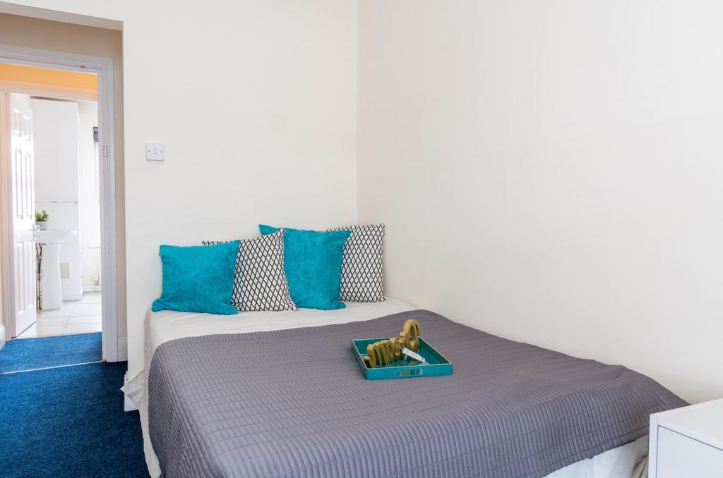 Cozy double bedroom featuring a comfortable bed...