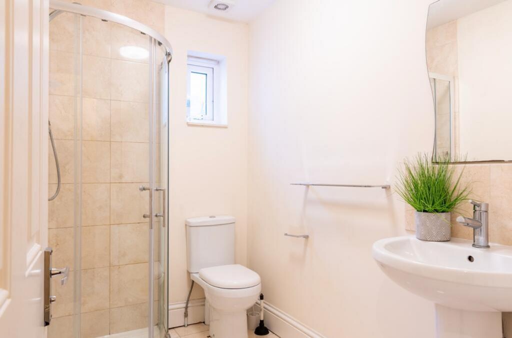 This modern bathroom features a stylish shower,...