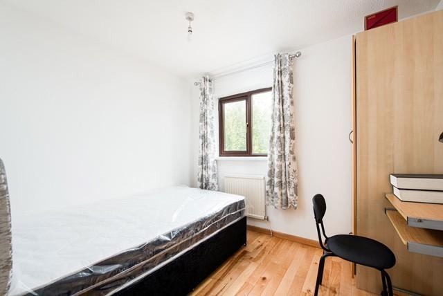 This inviting double bedroom features a cozy la...
