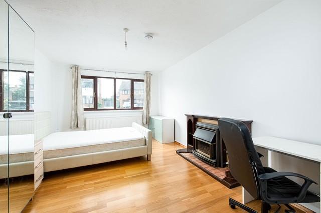 Bright and spacious double bedroom featuring la...