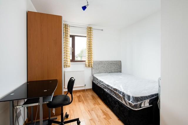 Cozy double bedroom featuring a comfortable bed...