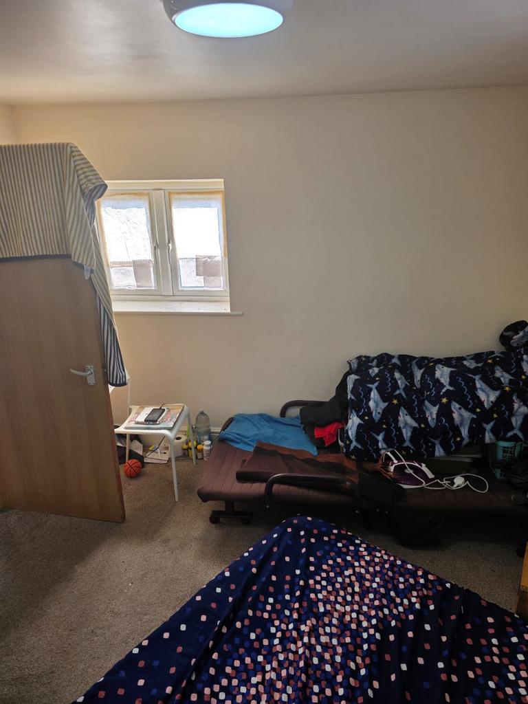 This cozy double bedroom features a comfortable...