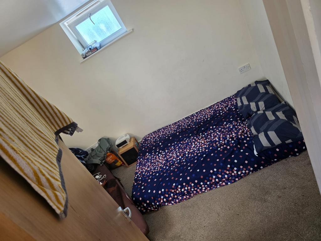 This cozy double bedroom features a comfortable...