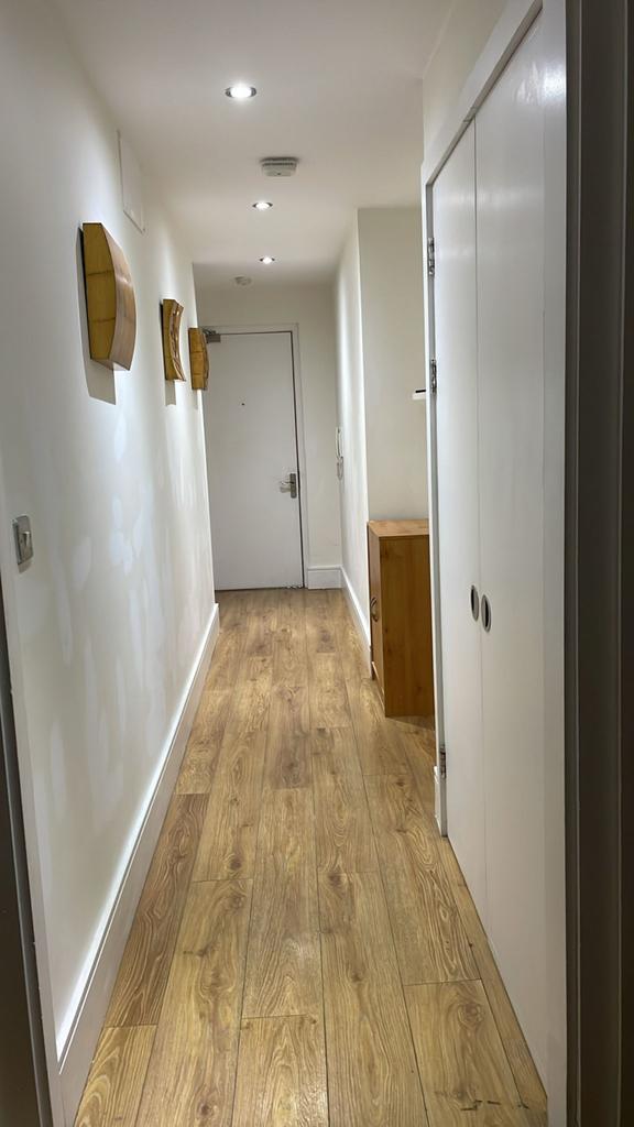 This spacious hallway features warm wooden floo...