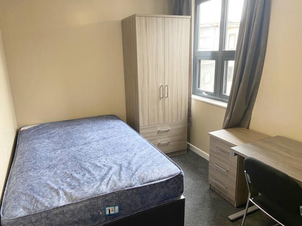 Cozy double bedroom featuring a comfortable bed...