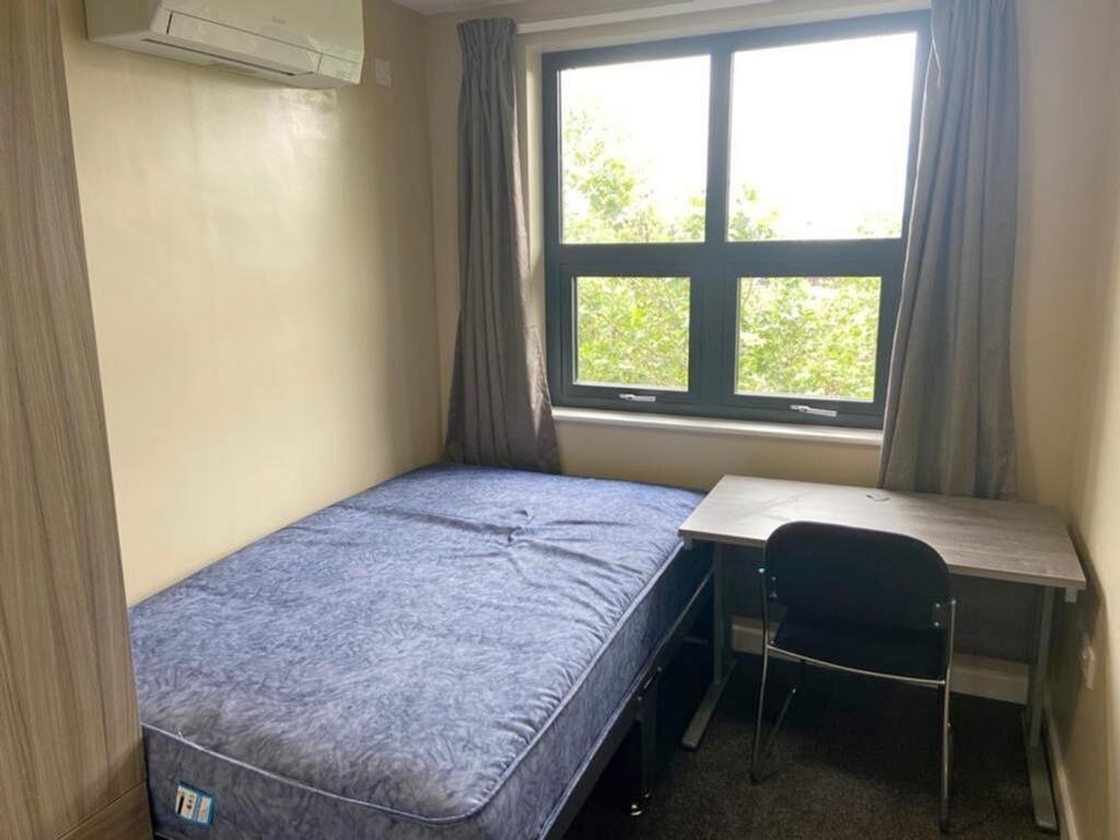 This inviting double bedroom features a comfort...
