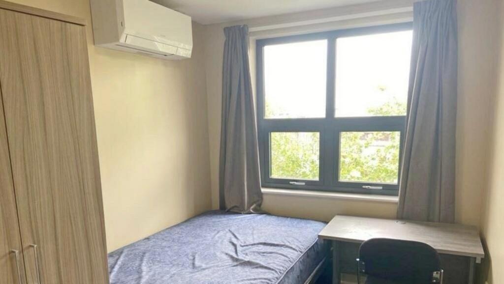 A bright and cozy double bedroom featuring a co...