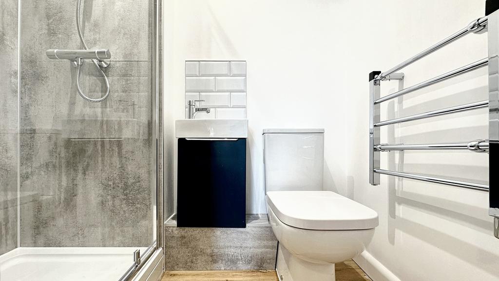 A modern bathroom featuring a sleek shower, sty...