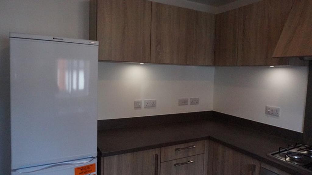 This modern kitchen features stylish wooden cab...