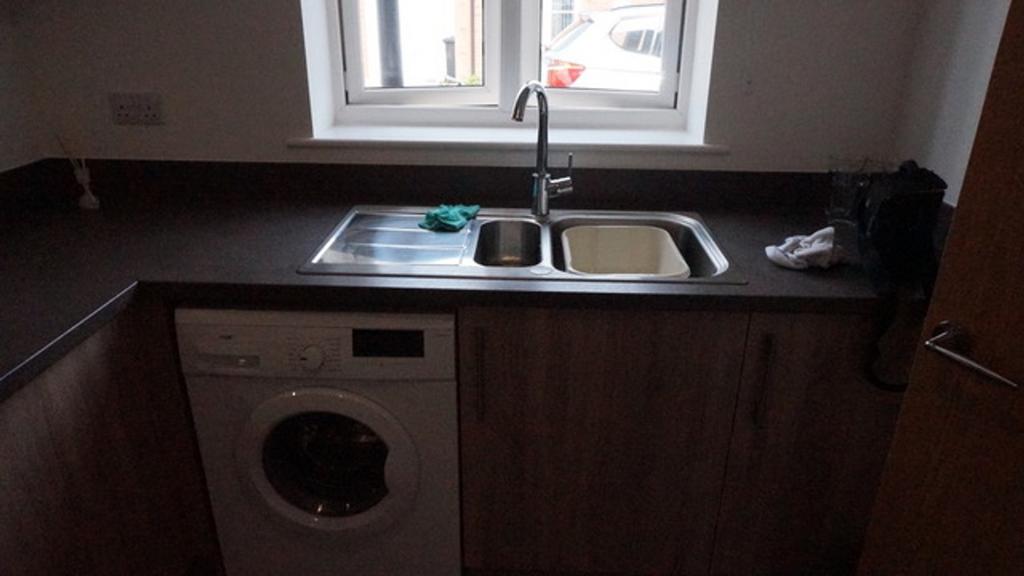 Modern kitchen featuring essential appliances, ...
