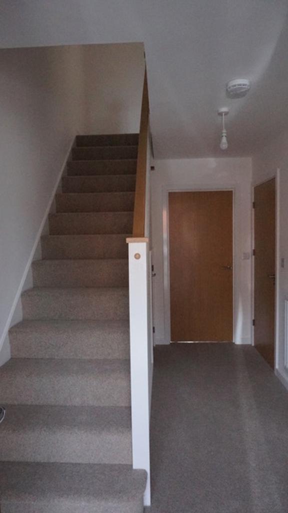A well-maintained staircase leading to upper le...