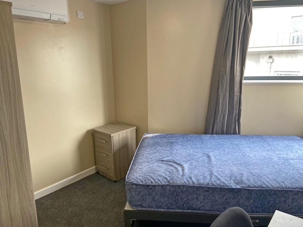 Spacious double bedroom featuring a comfortable...
