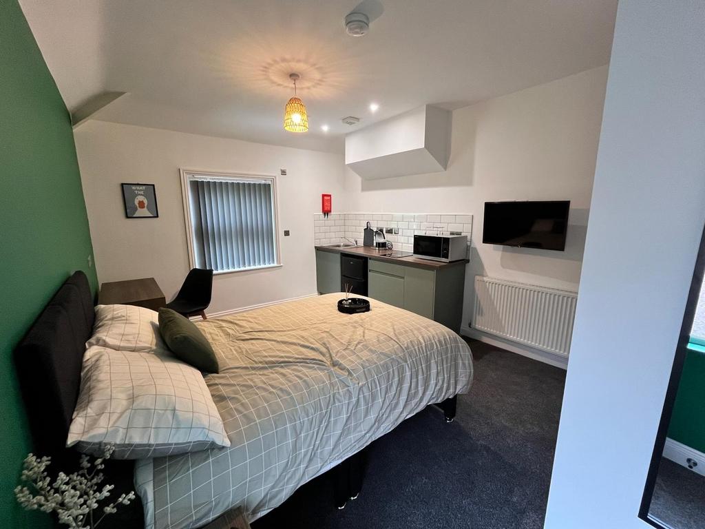 This inviting double bedroom features ample spa...