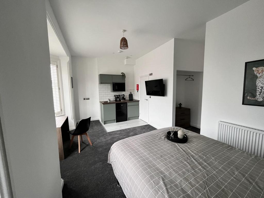 This inviting double bedroom features a cozy de...