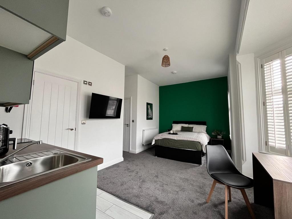 This inviting double bedroom features a cozy be...