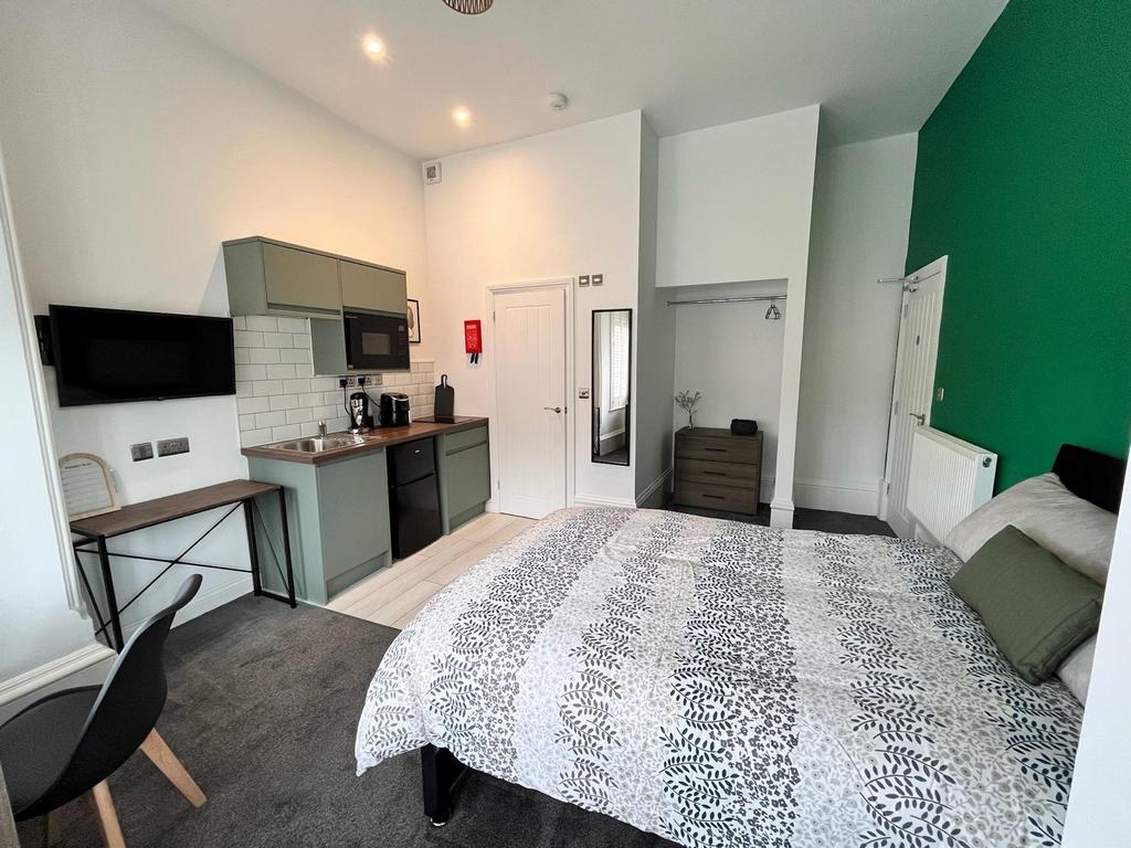 Stylish double bedroom featuring modern furnish...