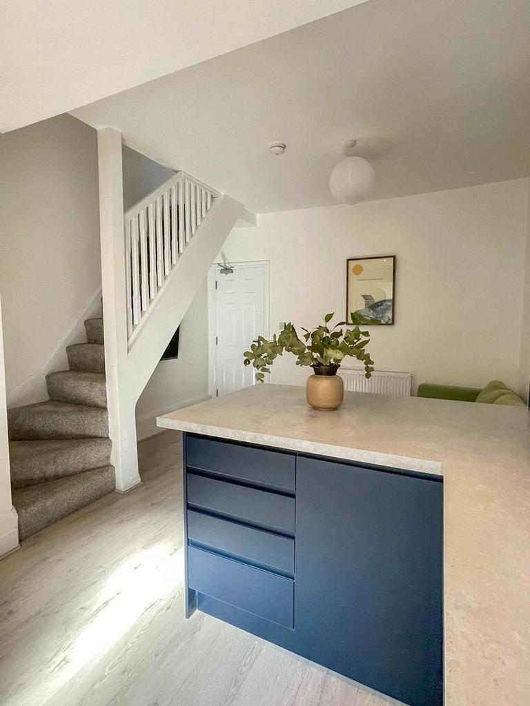 A bright and modern kitchen with a stylish isla...