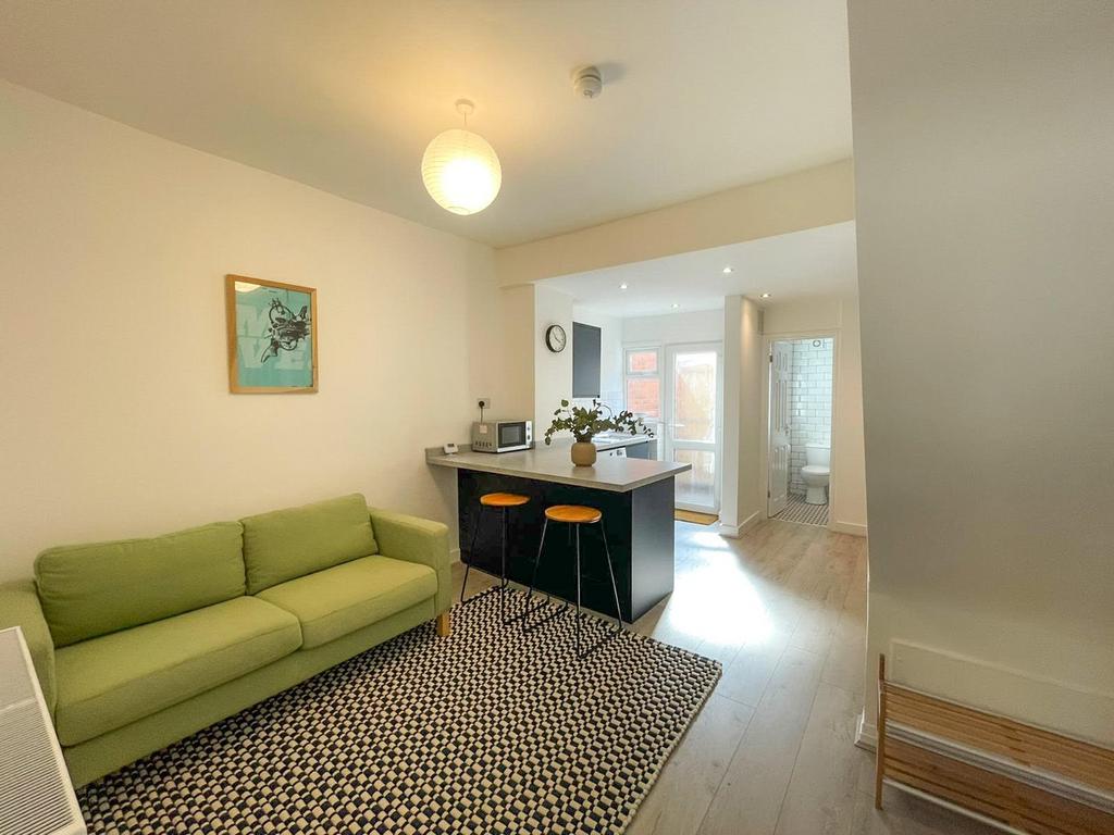 A spacious and modern living room featuring a c...