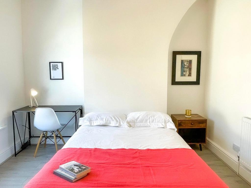 A bright and inviting double bedroom featuring ...