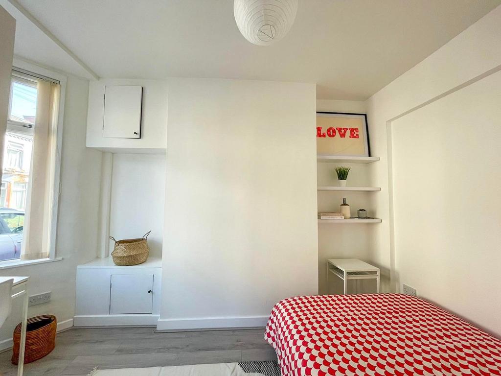 A bright and inviting double bedroom with a che...