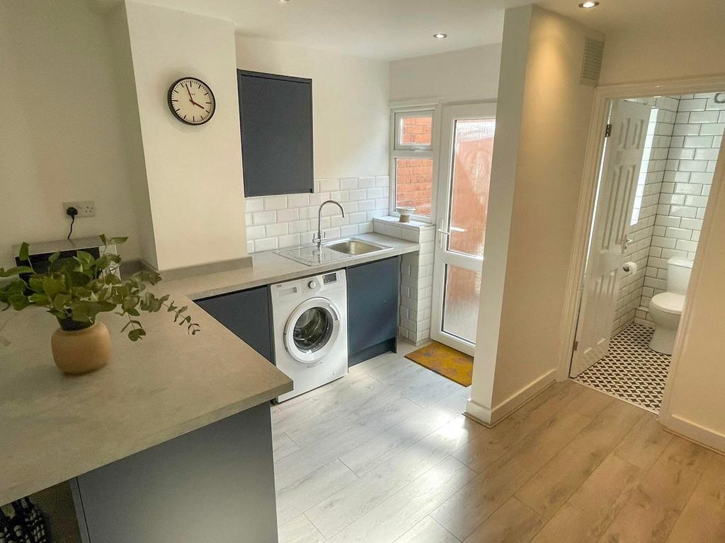 A bright and modern kitchen featuring ample spa...