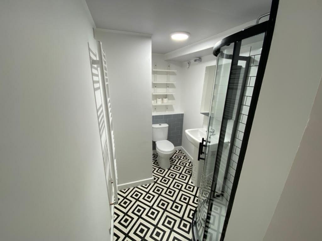 Modern bathroom suite featuring a stylish showe...