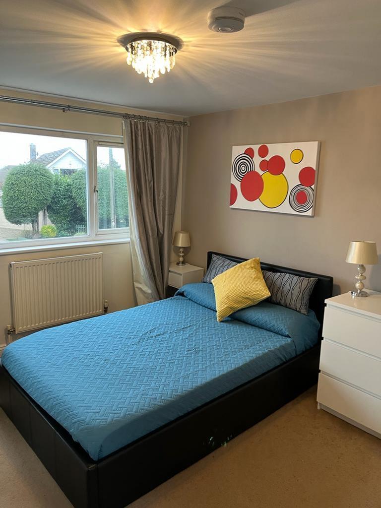 This inviting double bedroom features a comfort...